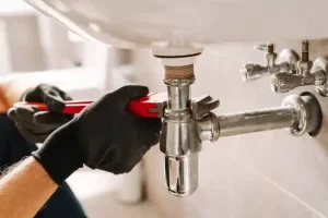 Inspecting and fixing under sink pipes